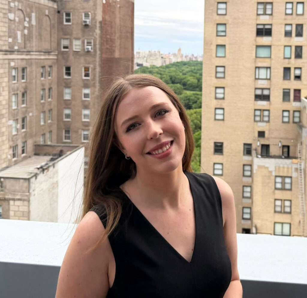 Grace Dunn standing in a black dress with the New York City skyline behind her — elite one-on-one SSAT tutor and founder of Crownridge Coaching