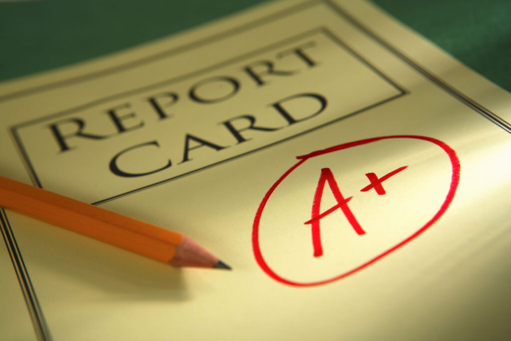 High school transcript with strong grades next to college admissions materials illustrating grade inflation